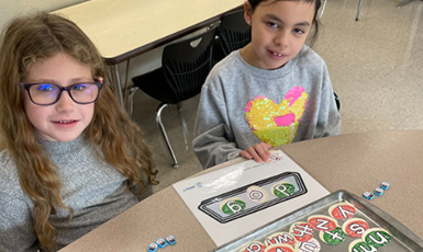  children learning a phonics lesson
